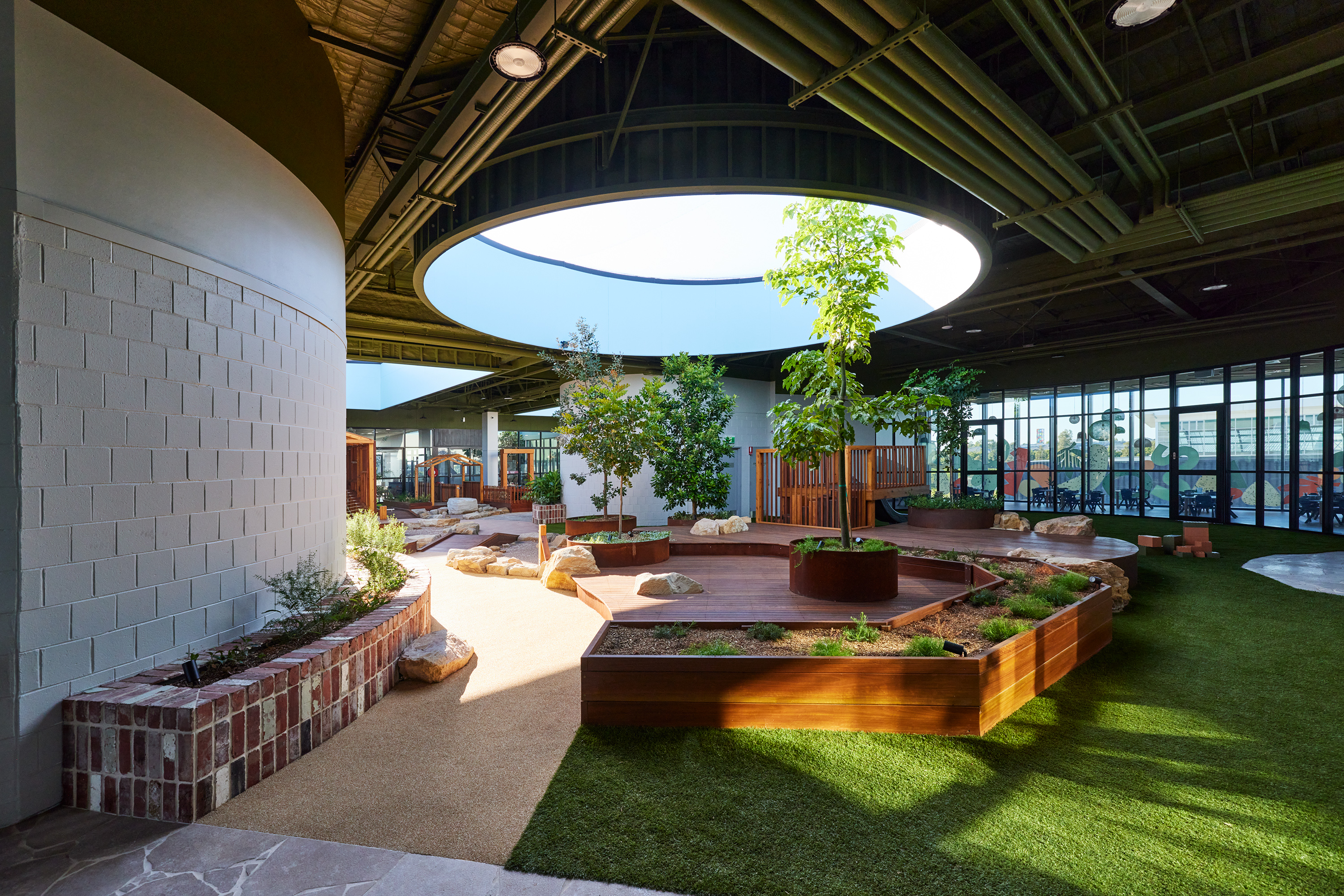 Children climbing, balancing and digging in a natural outdoor playspace designed by Wearthy